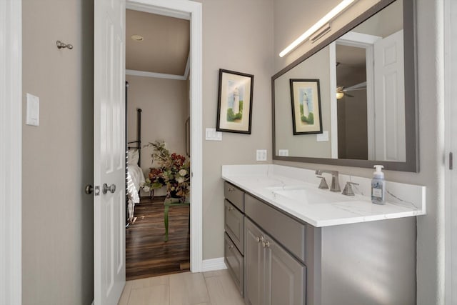 bathroom with ornamental molding and vanity