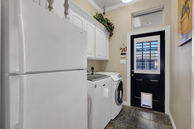 clothes washing area with cabinets, crown molding, and separate washer and dryer