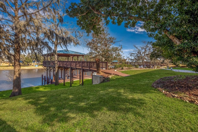 dock area with a yard, a gazebo, and a water view