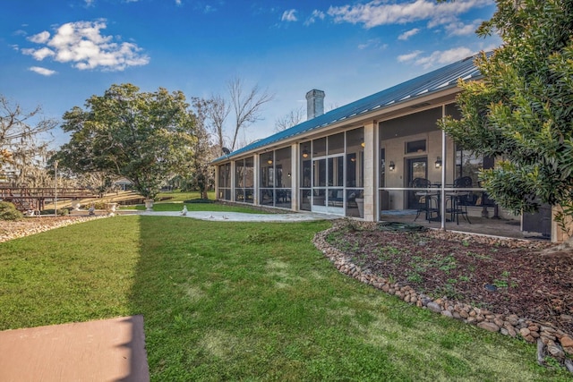 view of yard featuring a patio area and a sunroom