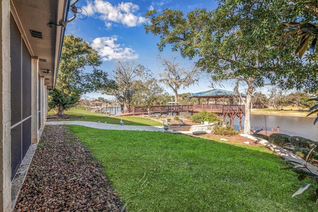 view of yard with a gazebo and a water view