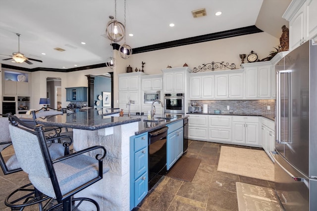 kitchen with a spacious island, stainless steel appliances, a kitchen breakfast bar, and white cabinets