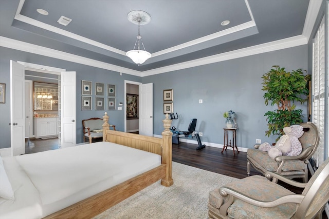 bedroom featuring dark wood-type flooring, crown molding, and a raised ceiling