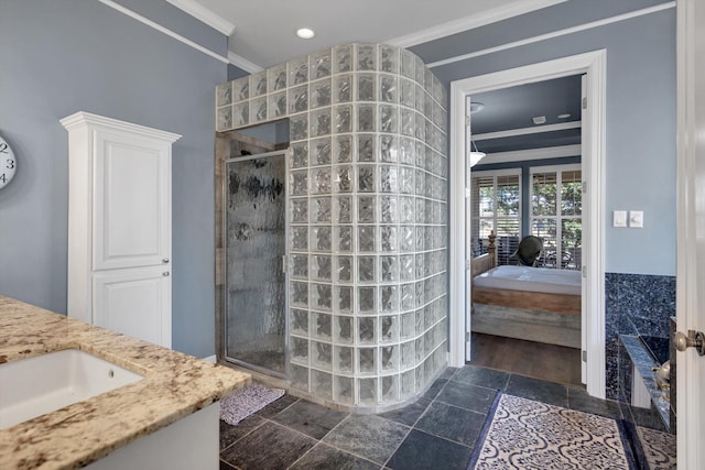 bathroom with vanity, crown molding, and a shower with door