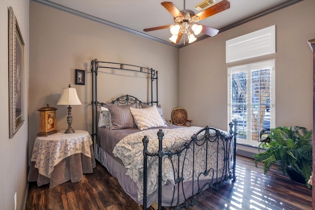 bedroom with ornamental molding, dark hardwood / wood-style floors, and ceiling fan