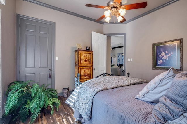 bedroom with hardwood / wood-style flooring, ornamental molding, and ceiling fan