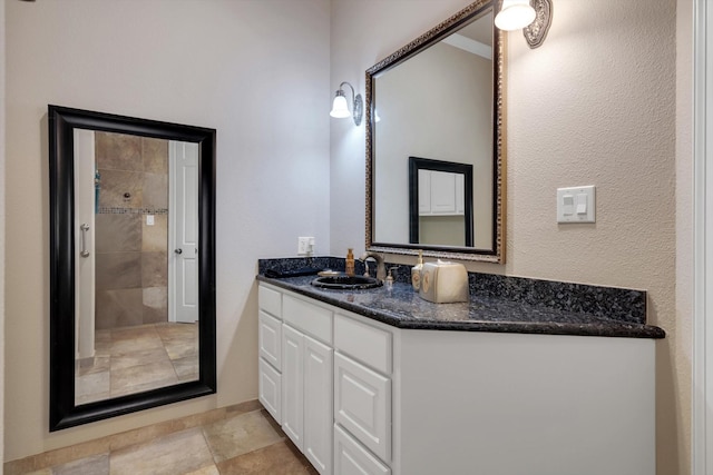 bathroom with walk in shower and vanity