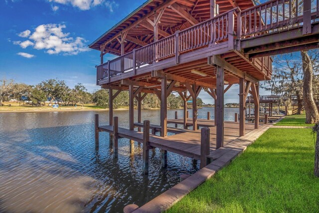 dock area featuring a water view and a yard