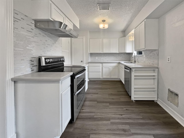 kitchen featuring decorative backsplash, range hood, white cabinets, and appliances with stainless steel finishes