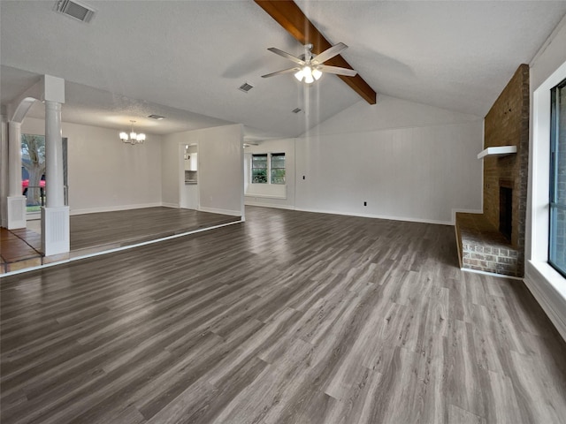 unfurnished living room featuring decorative columns, vaulted ceiling with beams, a brick fireplace, hardwood / wood-style flooring, and ceiling fan with notable chandelier