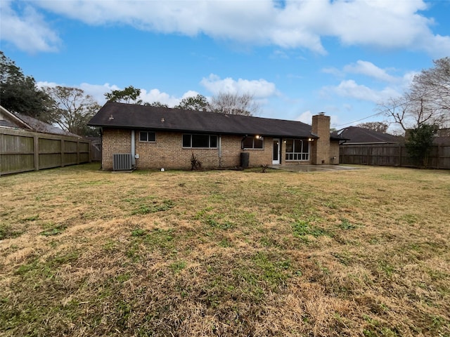 rear view of property featuring central AC, a patio area, and a lawn