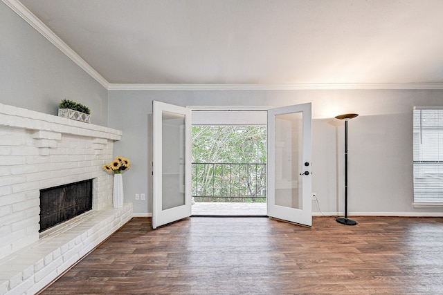 unfurnished living room featuring french doors, dark hardwood / wood-style floors, ornamental molding, and a fireplace