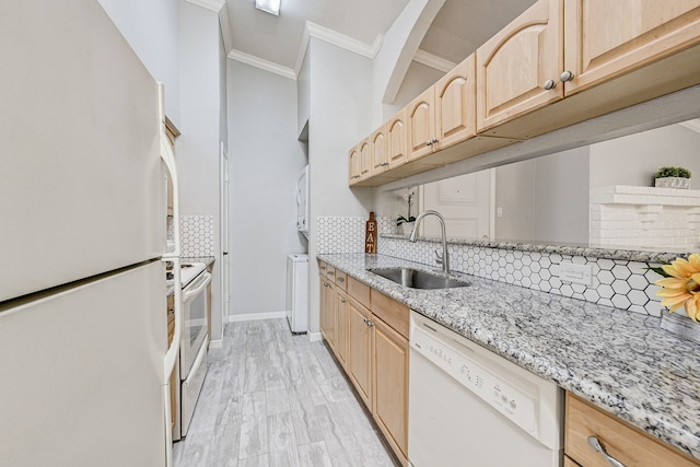 kitchen featuring tasteful backsplash, sink, crown molding, light brown cabinets, and white appliances