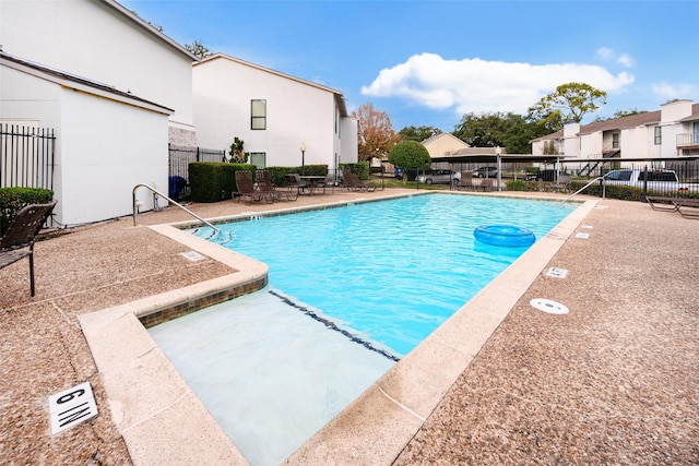 view of swimming pool with a patio area