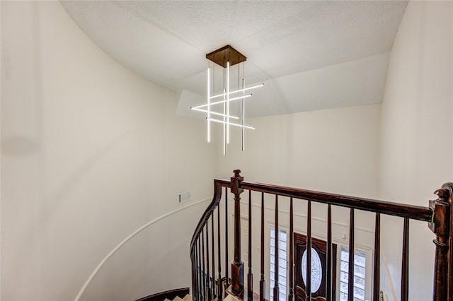 stairway with a textured ceiling