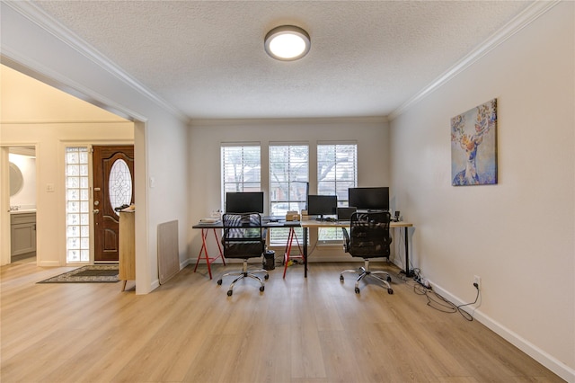 office space with crown molding, a textured ceiling, and light hardwood / wood-style floors