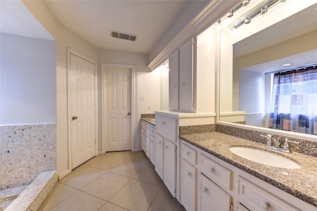 bathroom featuring tile patterned flooring and vanity