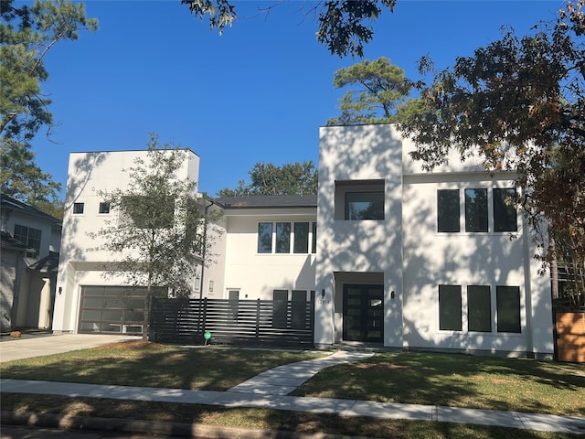 view of front of home with a garage and a front lawn