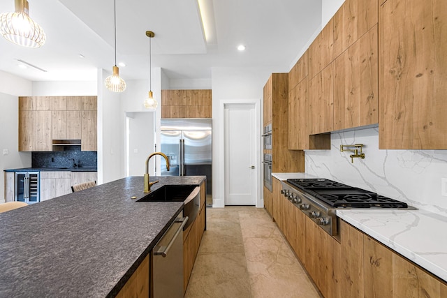 kitchen featuring pendant lighting, appliances with stainless steel finishes, wine cooler, decorative backsplash, and dark stone counters