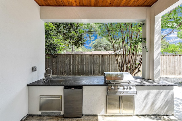 view of patio with area for grilling and sink