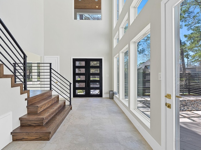 entryway with french doors and a high ceiling