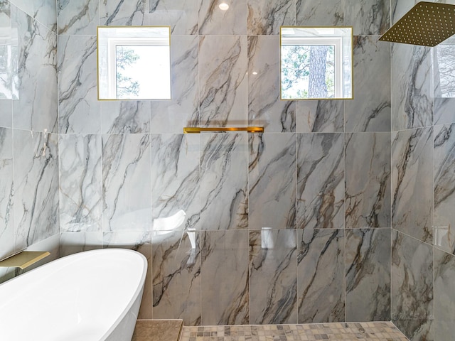 bathroom featuring shower with separate bathtub