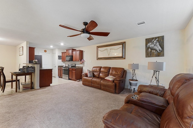 living room featuring light carpet and ceiling fan