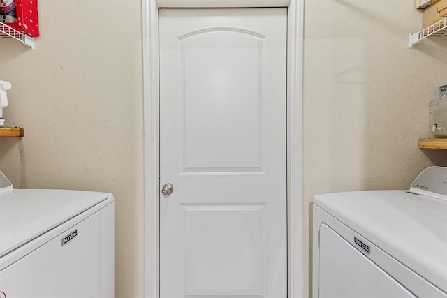 laundry area with washing machine and clothes dryer