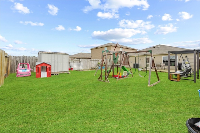 view of play area with a yard, central AC unit, and a storage unit