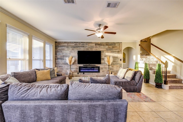 tiled living room featuring ornamental molding and ceiling fan