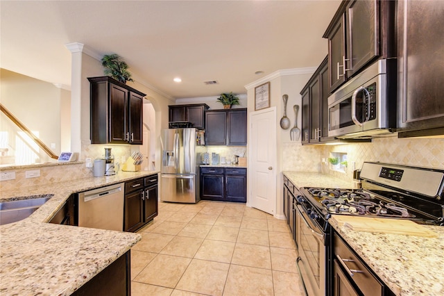 kitchen featuring light stone counters, appliances with stainless steel finishes, crown molding, and light tile patterned floors