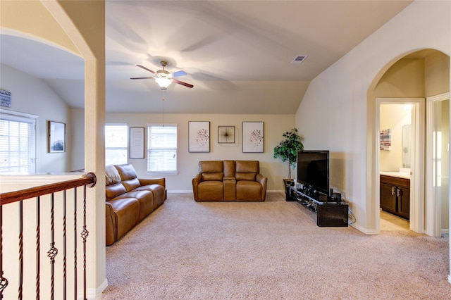 living room featuring lofted ceiling, a healthy amount of sunlight, light colored carpet, and ceiling fan