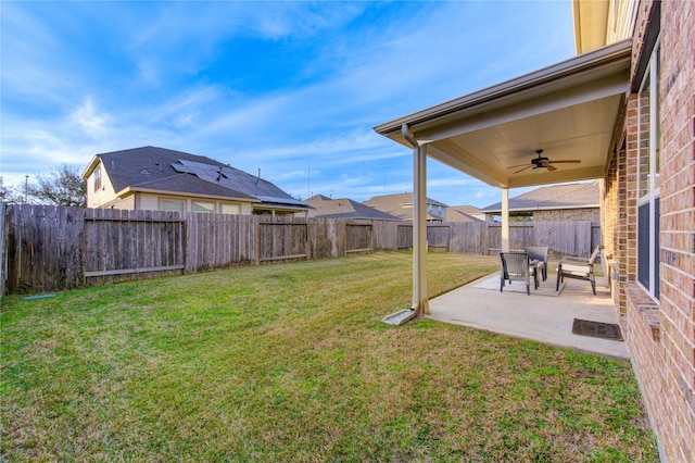 view of yard with ceiling fan and a patio