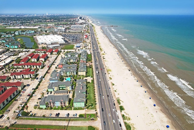 bird's eye view featuring a water view and a beach view