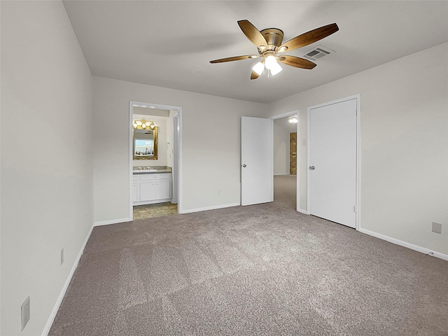 unfurnished bedroom with ceiling fan, ensuite bath, and carpet flooring