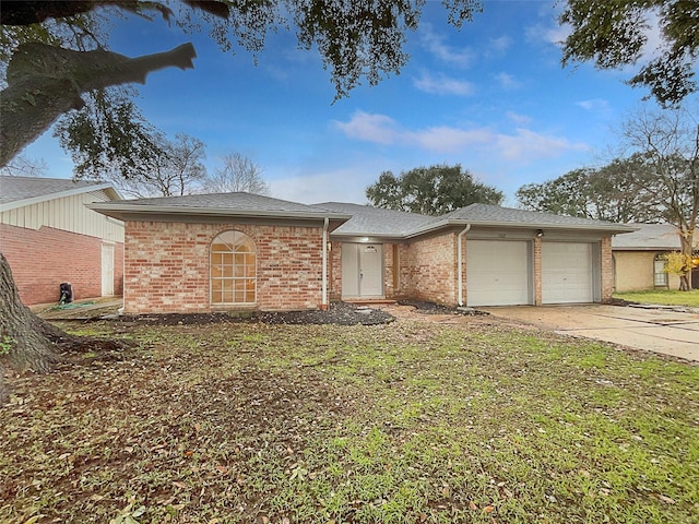 ranch-style home featuring a garage and a front yard