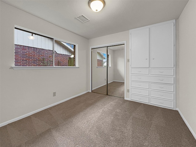 unfurnished bedroom with carpet and a closet