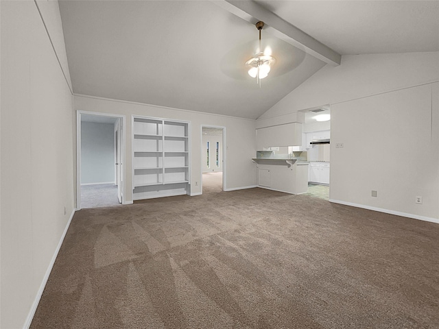 unfurnished living room featuring built in shelves, ceiling fan, carpet, and vaulted ceiling with beams