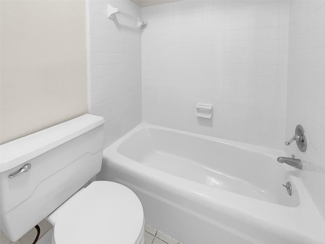 bathroom with tiled shower / bath combo and toilet