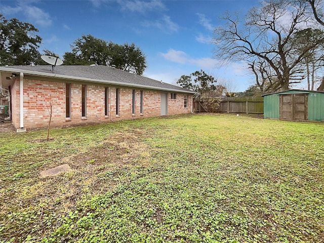 view of yard with central AC unit and a shed