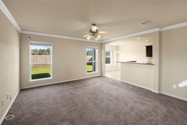 unfurnished living room featuring ornamental molding, carpet, and ceiling fan with notable chandelier