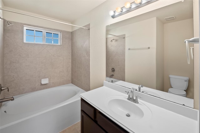 full bathroom featuring vanity, toilet, and tiled shower / bath