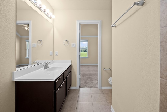 bathroom with tile patterned flooring, vanity, and toilet