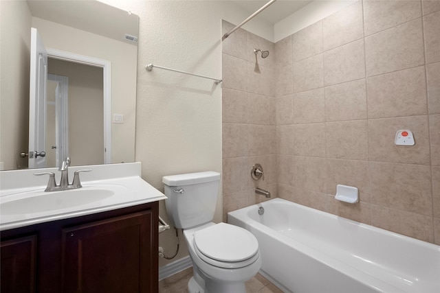 full bathroom featuring tiled shower / bath combo, vanity, and toilet