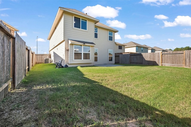 back of property featuring central AC and a lawn