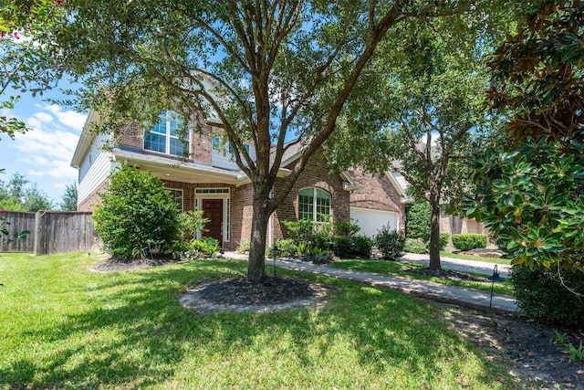 view of front of property featuring a garage and a front yard