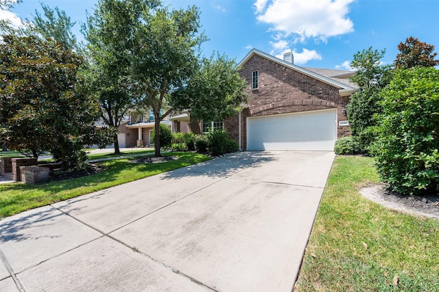 view of front of house with a garage and a front yard