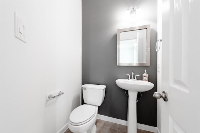 bathroom featuring tile patterned floors, toilet, and sink