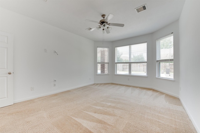 carpeted spare room featuring ceiling fan