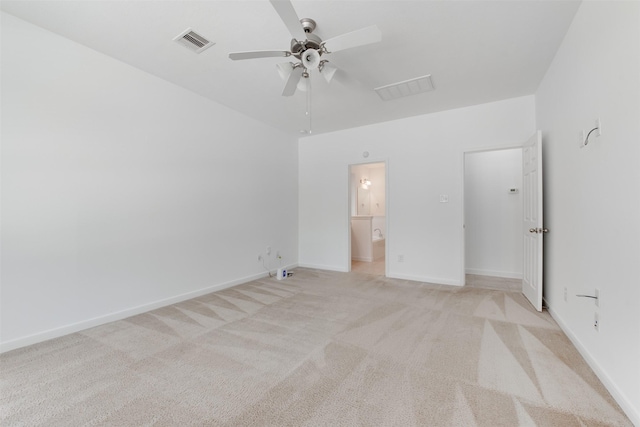 unfurnished bedroom featuring connected bathroom, light colored carpet, and ceiling fan